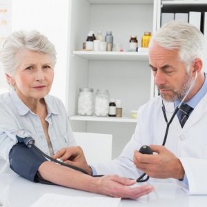 doctor-taking-blood-pressure-of-his-retired-patient